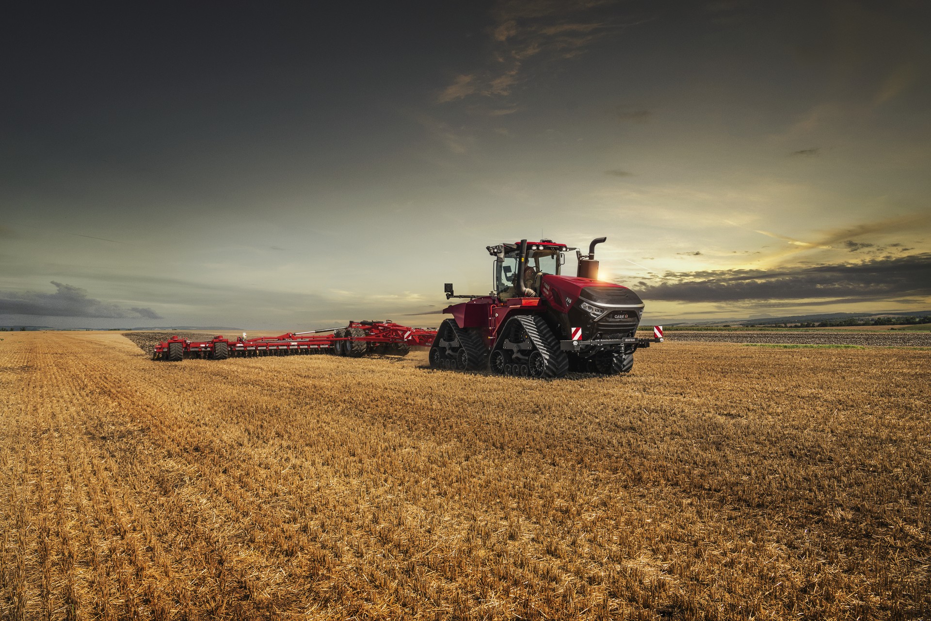 Case IH tractor in an Alberta field at sunset